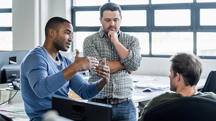 A photo of businessman sharing ideas with colleagues for improvement.